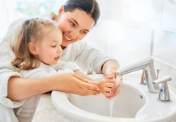 mother-helping-daughter-wash-her-hands